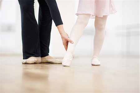 Close up of a young ballerina and teacher practicing toe point Stock Photo - Premium Royalty-Free, Code: 649-07063688