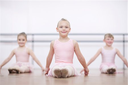 simsearch:649-07063701,k - Young ballerinas in pose whilst sitting on floor Fotografie stock - Premium Royalty-Free, Codice: 649-07063698