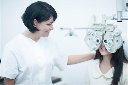 Young woman at opticians having eye test Stock Photo - Premium Royalty-Free, Code: 649-07063767