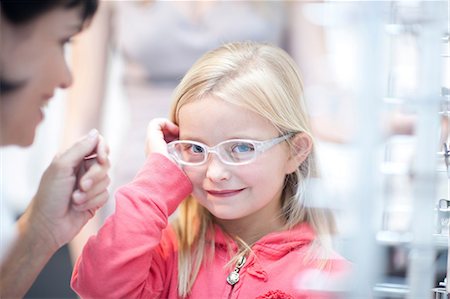 eyeglasses not sunglasses - Young girl on choosing eyeglasses Stock Photo - Premium Royalty-Free, Code: 649-07063791