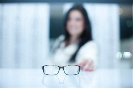 simsearch:649-07063767,k - Woman and a pair of eyeglasses Stock Photo - Premium Royalty-Free, Code: 649-07063806