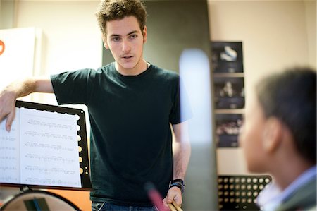 pic of 18 year boy in brown hair - Young male teaching boy how to play drums Stock Photo - Premium Royalty-Free, Code: 649-07063861