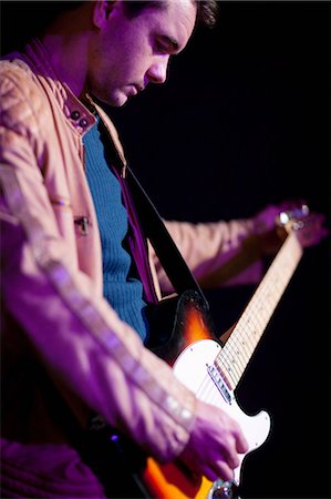 spotlight on stage - Close up of man playing guitar Stock Photo - Premium Royalty-Free, Code: 649-07063885