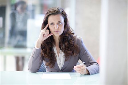 Young stressed businesswoman in office Stock Photo - Premium Royalty-Free, Code: 649-07063901