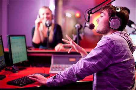 radio mic - Young man and woman broadcasting in recording studio Stock Photo - Premium Royalty-Free, Code: 649-07063935