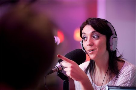 radio mic - Mid adult woman broadcasting in recording studio Stock Photo - Premium Royalty-Free, Code: 649-07063945