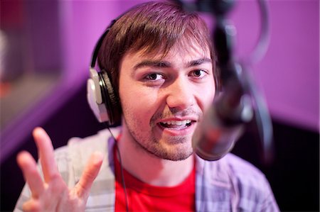 radio mic - Young man broadcasting in recording studio, portrait Stock Photo - Premium Royalty-Free, Code: 649-07063942