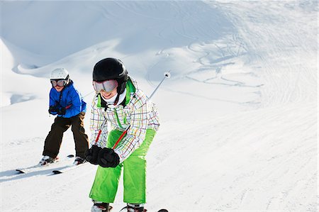 Brother and sister skiing downhill, Les Arcs, Haute-Savoie, France Stock Photo - Premium Royalty-Free, Code: 649-07118134