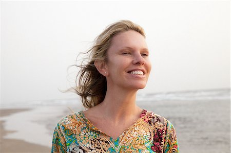 Woman smiling enjoying sea breeze Stock Photo - Premium Royalty-Free, Code: 649-07118146