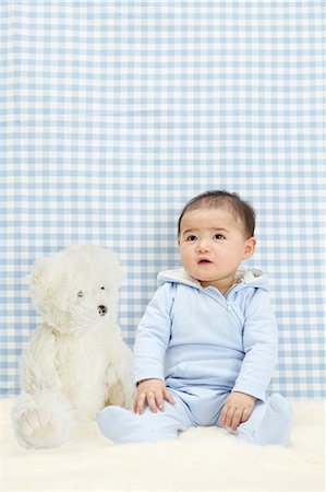 Baby boy sitting with soft toy Stock Photo - Premium Royalty-Free, Code: 649-07118168