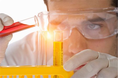 science laboratory - Close up of scientist pouring liquid into test tube Stock Photo - Premium Royalty-Free, Code: 649-07118200