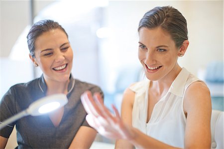 spa treatment woman - Woman admiring her fingernails after beauty treatment Stock Photo - Premium Royalty-Free, Code: 649-07118217