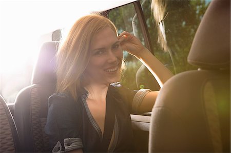 road trip woman car - Young woman travelling in back seat of car Stock Photo - Premium Royalty-Free, Code: 649-07118472