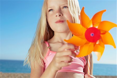 sunny holiday girl - Girl holding toy windmill Stock Photo - Premium Royalty-Free, Code: 649-07118498