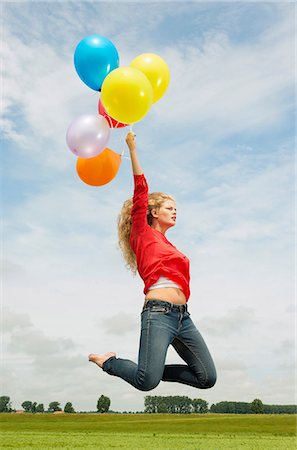 Woman jumping with balloons Foto de stock - Sin royalties Premium, Código: 649-07118512