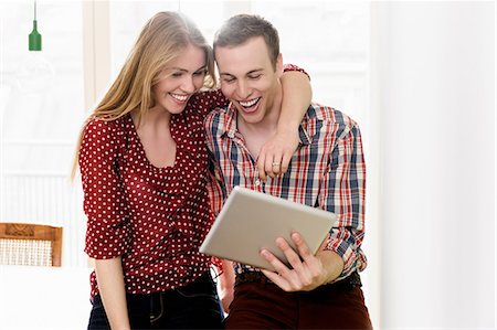 digital tablet and young adult laughing - Couple on video chat using digital tablet Stock Photo - Premium Royalty-Free, Code: 649-07118537