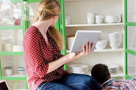 Girl with digital tablet looking sideways Stock Photo - Premium Royalty-Free, Code: 649-07118544