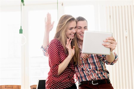 people wave hello - Couple on video chat using digital tablet Stock Photo - Premium Royalty-Free, Code: 649-07118540