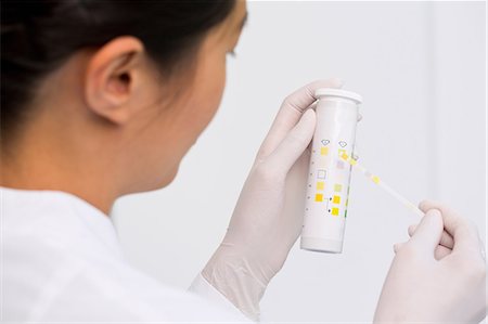 Female scientist testing urine sample Stock Photo - Premium Royalty-Free, Code: 649-07118802