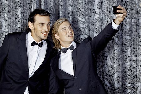 dinner jacket - Two young men making self portrait on mobile phone Stock Photo - Premium Royalty-Free, Code: 649-07118872