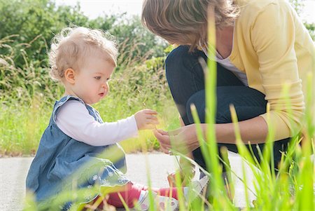 family fun outdoors summer grass - Mother and daughter looking at grass Stock Photo - Premium Royalty-Free, Code: 649-07118967