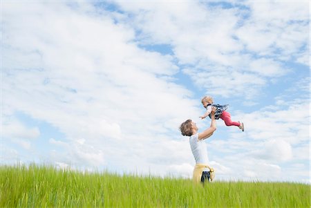 summer grass - Mother lifting daughter in field Stock Photo - Premium Royalty-Free, Code: 649-07118973