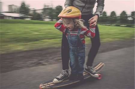 skateboard - Mother and daughter riding on skateboard in park Stock Photo - Premium Royalty-Free, Code: 649-07119098