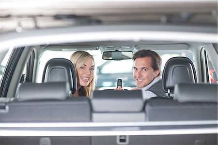 simsearch:649-07119148,k - Couple sitting in new car in showroom Photographie de stock - Premium Libres de Droits, Code: 649-07119144