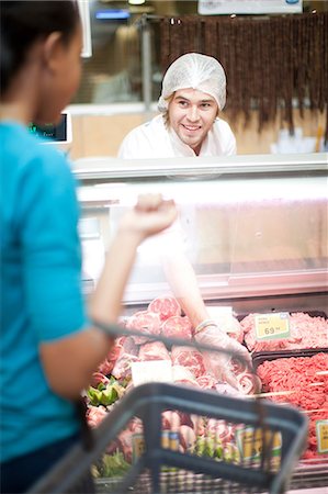 serving (food at restaurant) - Young male sales assistant serving female customer Stock Photo - Premium Royalty-Free, Code: 649-07119169