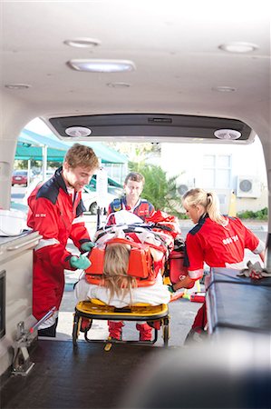 Paramedics lifting patient into ambulance Stock Photo - Premium Royalty-Free, Code: 649-07119232