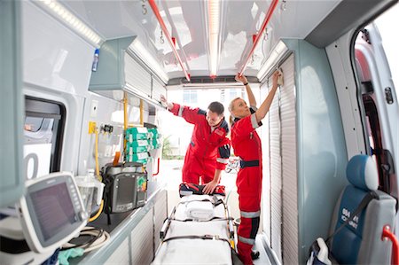 Paramedics in ambulance preparing medical equipment Stock Photo - Premium Royalty-Free, Code: 649-07119248