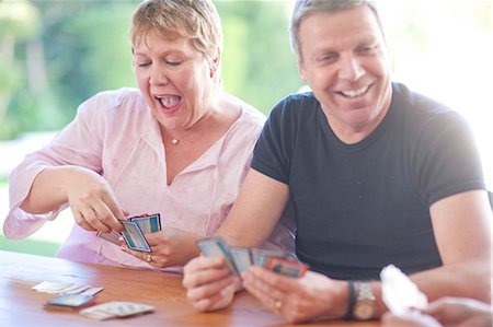 family playing games indoors - Mature male playing cards with sister Stock Photo - Premium Royalty-Free, Code: 649-07119279