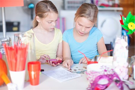 devices finance - Two young sisters checking stall profits Stock Photo - Premium Royalty-Free, Code: 649-07119287