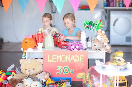 financial goal - Two young sisters setting up stall Stock Photo - Premium Royalty-Free, Code: 649-07119280