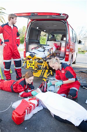 emergency vehicle - Ambulance and paramedics attending patient on road Photographie de stock - Premium Libres de Droits, Code: 649-07119308