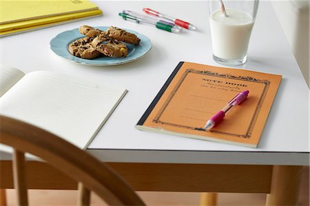 Kitchen table still life with notebooks, biscuits and milk Photographie de stock - Premium Libres de Droits, Code: 649-07119302