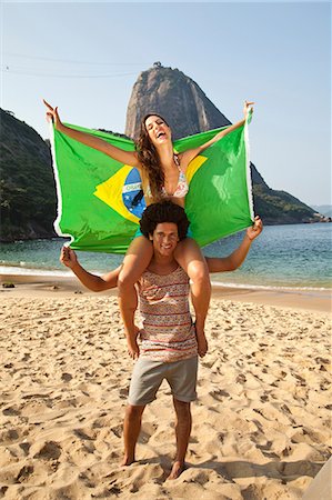 Couple on beach with Brazilian flag, Rio de Janeiro, Brazil Stock Photo - Premium Royalty-Free, Code: 649-07119344