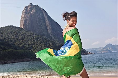 Man on beach with Brazilian flag, Rio de Janeiro, Brazil Stock Photo - Premium Royalty-Free, Code: 649-07119368