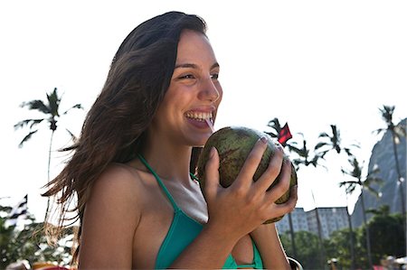 Young woman drinking coconut drink Stock Photo - Premium Royalty-Free, Code: 649-07119384