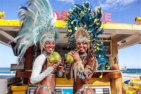 Two samba dancers drinking coconut drinks, Ipanema Beach, Rio, Brazil Stock Photo - Premium Royalty-Free, Code: 649-07119506