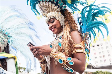 Samba dancer using cellphone, Rio De Janeiro, Brazil Stock Photo - Premium Royalty-Free, Code: 649-07119525