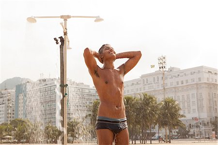 ducha - Young man showering on Copacabana Beach, Rio de Janeiro, Brazil Foto de stock - Sin royalties Premium, Código: 649-07238294
