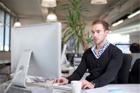 Man using computer in office Stock Photo - Premium Royalty-Free, Code: 649-07238422