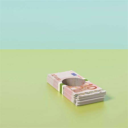 Pile of Euro notes with hole through the middle Stock Photo - Premium Royalty-Free, Code: 649-07238437