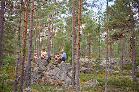 simsearch:649-07280291,k - Family sitting on rocks in forest eating picnic Stock Photo - Premium Royalty-Free, Code: 649-07238447