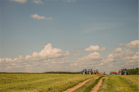 Tractors harvesting field Stock Photo - Premium Royalty-Free, Code: 649-07238442