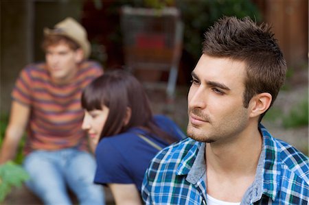 simsearch:649-07238907,k - Portrait of young man with friends in background Stock Photo - Premium Royalty-Free, Code: 649-07238533