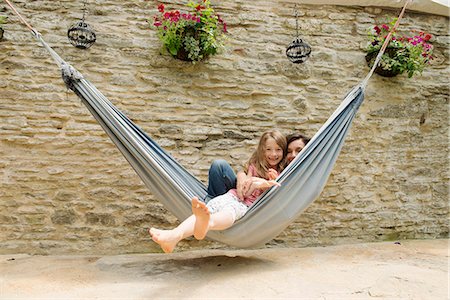 family joy mother child caucasian - Portrait of mother and daughter in hammock Stock Photo - Premium Royalty-Free, Code: 649-07238625