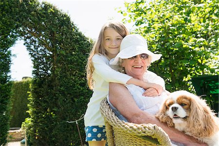 senior woman granddaughter - Portrait of grandmother and granddaughter with dog Stock Photo - Premium Royalty-Free, Code: 649-07238636