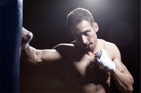 simsearch:649-07238779,k - Boxer training with punch bag Foto de stock - Sin royalties Premium, Código: 649-07238773